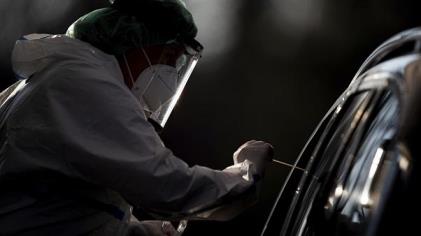 An employee takes a smear sample for a new coro<em></em>navirus COVID-19 test  in Nuertingen, Germany, Wednesday, Nov 25, 2020. 