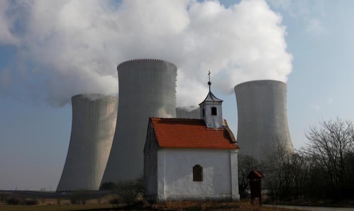 A chapel is seen in front of the cooling towers of the Czech nuclear power plant at Dukovany, 125 miles (200 kM) east from Prague, March 15, 2011. REUTERS/Petr Josek/File Photo