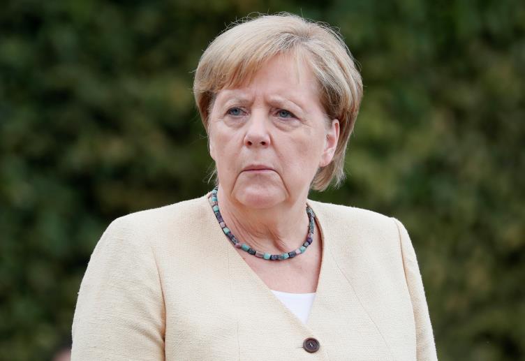 German Chancellor Angela Merkel takes part in a wreath-laying ceremony at the Tomb of the Unknown Soldier in Kyiv, Ukraine August 22, 2021. REUTERS/Gleb Garanich