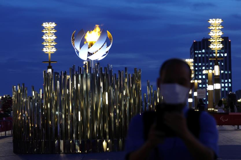 A man wearing a protective mask, amid the coro<em></em>navirus disease (COVID-19) pandemic, stands in front of the second Paralympic flame cauldron at Ariake Yume-no-Ohashi Bridge, a day after the official opening of Tokyo 2020 Paralympic Games, in Tokyo, Japan, August 25, 2021.   REUTERS/Kim Kyung-Hoon