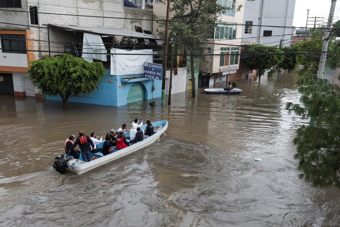 Rescue teams evacuate residents in a boat through flooded streets after heavy rainfall during Monday's night in the municipality of Tula de Allende, which left people dead, injured and cars and infrastructure damaged, in Tula de Allende, on the outskirts of Mexico City, Mexico September 7, 2021. REUTERS/Henry Romero