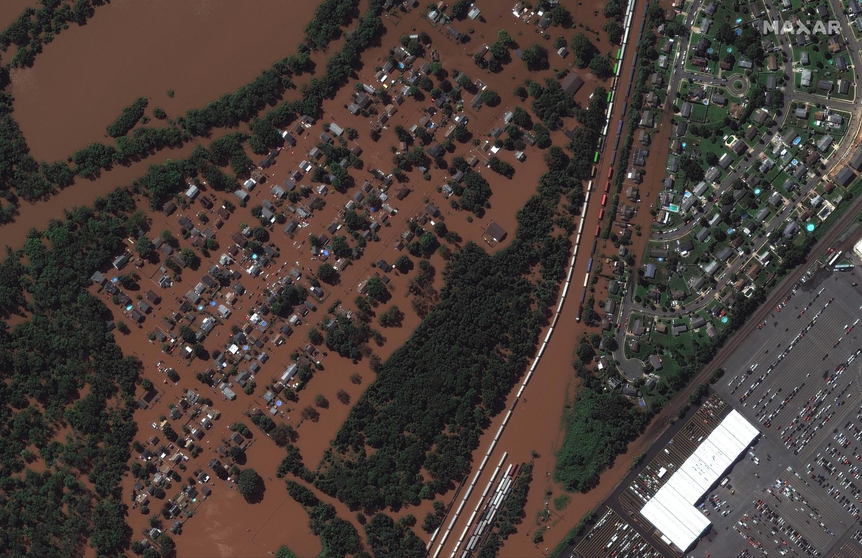 A satellite image shows a rail yard and homes along Huff Avenue submerged in floodwater after torrential rains swept through Manville, New Jersey, U.S., following the passing of Hurricane Ida, September 2, 2021. Satellite image copyright 2021 Maxar Technologies/Handout via REUTERS 