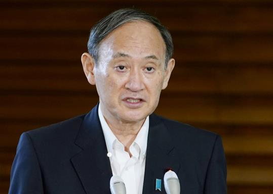 Japan's Prime Minister Yoshihide Suga speaks to media after reports on North Korea fired a pair of ballistic missiles at his official residence in Tokyo, Japan September 15, 2021, in this photo taken by Kyodo. Mandatory credit Kyodo/via REUTERS    