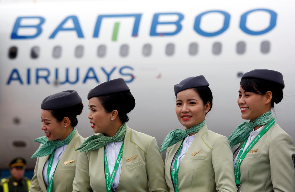 Crew members stand near an Airbus A321 aircraft of Bamboo Airways before a flight at Noi Bai airport in Hanoi, Vietnam January 16, 2019. REUTERS/Kham