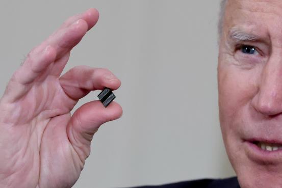 U.S. President Joe Biden holds a semico<em></em>nductor chip as he speaks prior to signing an executive order, aimed at addressing a global semico<em></em>nductor chip shortage, in the State Dining Room at the White House in Washington, U.S., February 24, 2021. REUTERS/Jo<em></em>nathan Ernst/File Photo