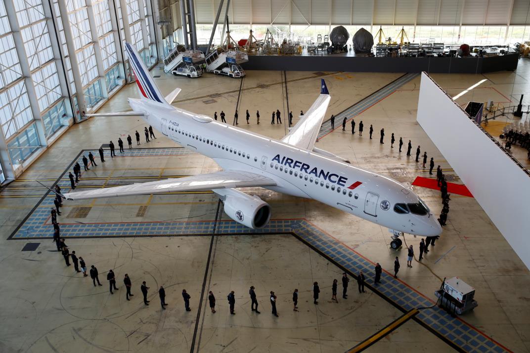 Air France employees stand around the first Air France airliner's Airbus A220 during a ceremony in the Air France hangar at Paris Charles de Gaulle airport in Roissy near Paris, France, September 29, 2021. REUTERS/Go<em></em>nzalo Fuentes