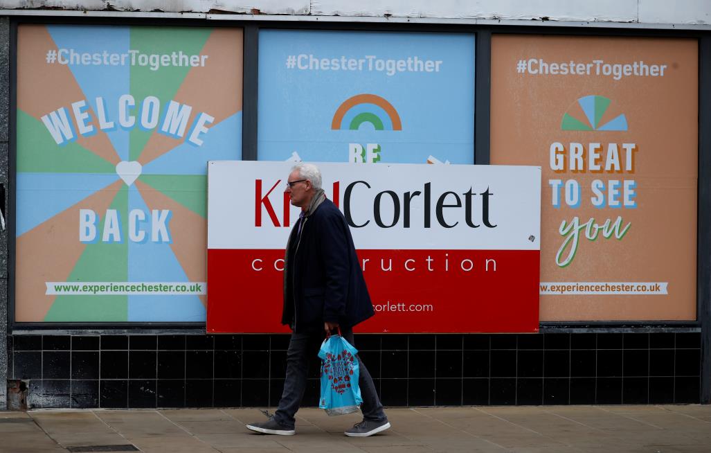 A man walks past a closed retail unit in the centre of Chester, Britain, October 26, 2021. REUTERS/Phil Noble