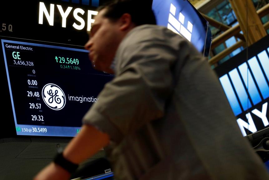 A trader passes by the post wher<em></em>e General Electric is traded on the floor of the New York Stock Exchange (NYSE) in New York City, U.S. October 31, 2016.  REUTERS/Brendan McDermid/File Photo