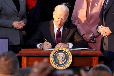 U.S. President Joe Biden signs the 