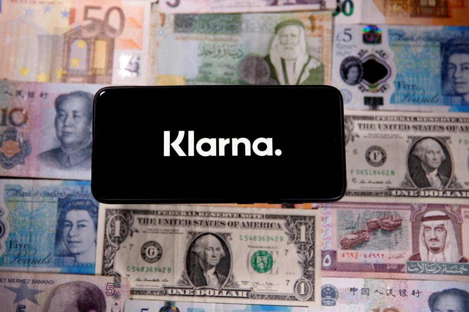 A smartphone displays a Klarna logo on top of banknotes is in this illustration taken January 6, 2020. REUTERS/Dado Ruvic