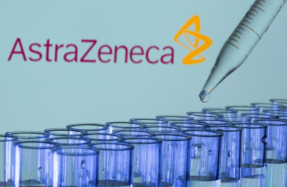 Test tubes are seen in front of a displayed AstraZeneca logo in this illustration taken, May 21, 2021. REUTERS/Dado Ruvic/Illustration