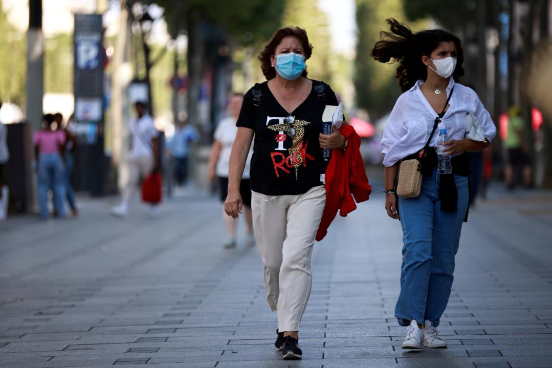 People wearing protective face masks walk on the Champs Elysees Avenue in Paris, amid the coro<em></em>navirus disease (COVID-19) outbreak, in France, July 22, 2021. REUTERS/Sarah Meyssonnier