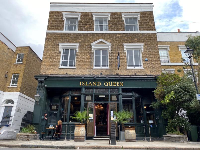 Customers are seen at a table outside The Island Queen pub, which is run by Mitchells & Butlers in Islington, London, Britain, September 24, 2020. REUTERS/Simon Newman