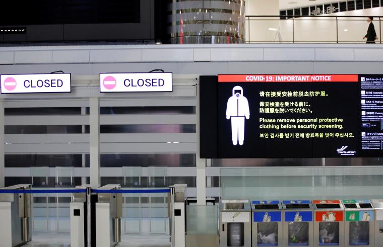 A notice a<em></em>bout COVID-19 safety measures is pictured next to closed doors at a departure hall of Narita internatio<em></em>nal airport on the first day of closed borders to prevent the spread of the new coro<em></em>navirus Omicron variant in Narita, east of Tokyo, Japan, November 30, 2021. REUTERS/Kim Kyung-Hoon/File Photo