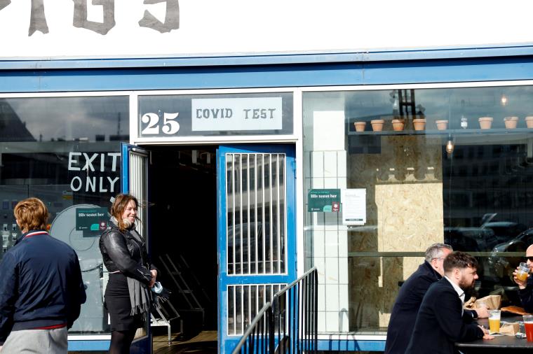 A woman waits in line to get a coro<em></em>navirus disease (COVID-19) antigen test at a bar in central Copenhagen, Denmark, April 23, 2021. REUTERS/Tim Barsoe