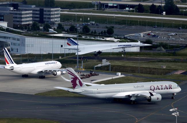 A Qatar Airways Airbus A350 passes by the retired Air France Co<em></em>ncorde number 5 on the tarmac at Paris Charles de Gaulle airport in Roissy-en-France during the outbreak of the coro<em></em>navirus disease (COVID-19) in France May 25, 2020. REUTERS/Charles Platiau