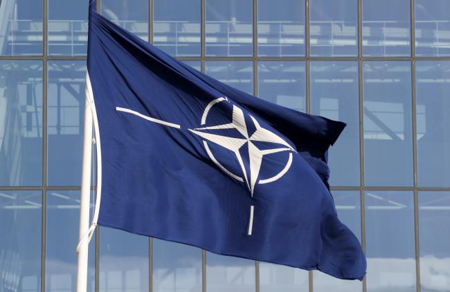 A NATO flag is seen at the Alliance headquarters ahead of a NATO Defence Ministers meeting, in Brussels, Belgium, October 21, 2021. REUTERS/Pascal Rossignol/Files