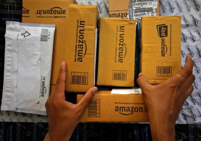 A worker sorts delivery packages in a van outside an Amazon facility in Ahmedabad, India, March 17, 2021. REUTERS/Amit Dave