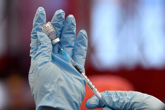 Nurse Christina McCavana prepares the vials of the Pfizer coro<em></em>navirus disease (COVID-19) vaccine for use at a pop-up vaccination clinic in the Central Fire Station in Belfast, Northern Ireland, December 4, 2021. REUTERS/Clodagh Kilcoyne