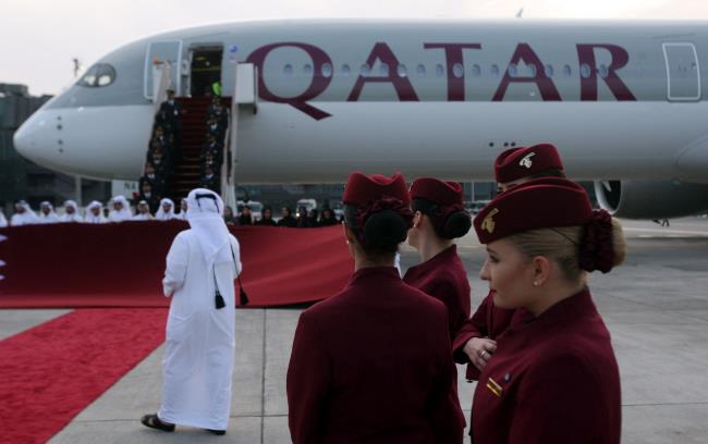 Qatar Airways cabin crew stand in front of an Airbus A350-1000 at Hamad Internatio<em></em>nal Airport in Doha, Qatar, February 21, 2018. REUTERS/Naseem Zeitoon