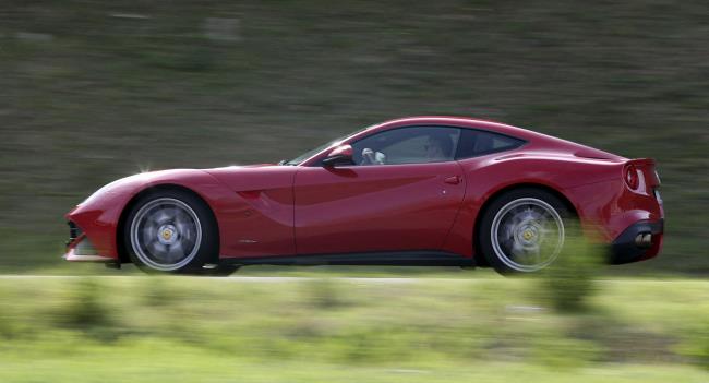 A man drives a Ferrari luxury car in Ferrari's hometown of Maranello, Italy, October 9, 2015. REUTERS/Stefano Rellandini/File Photo