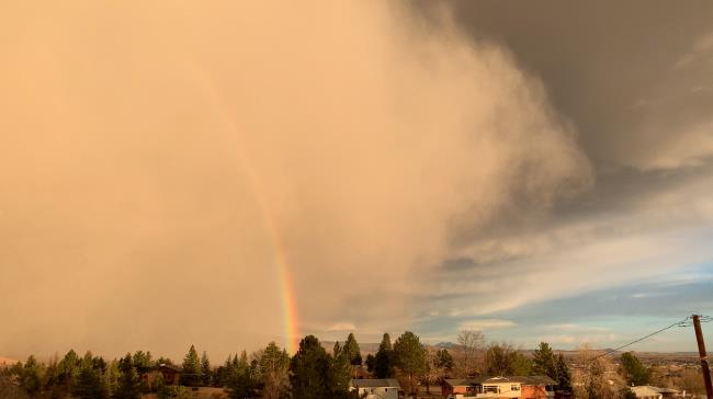 A rainbow and a cloud of dust storm are observed in Boulder, Colorado, U.S. December 15, 2021 in this screen grab obtained from a social media video. Matt Benjamin/via REUTERS