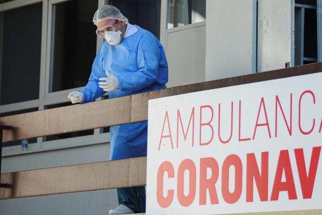 A medical worker stands in front of ambulance for coro<em></em>navirus disease (COVID-19) in Pristina, Kosovo, March 16, 2020. REUTERS/Laura Hasani