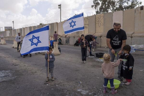 People gather at Israel's Nitzana border crossing with Egypt in southern Israel, Tuesday, Feb. 27, 2024, protesting against the delivery of humanitarian aid to the Gaza Strip until all hostages held by Hamas militants are released. Picture: AP Photo/Ohad Zwigenberg