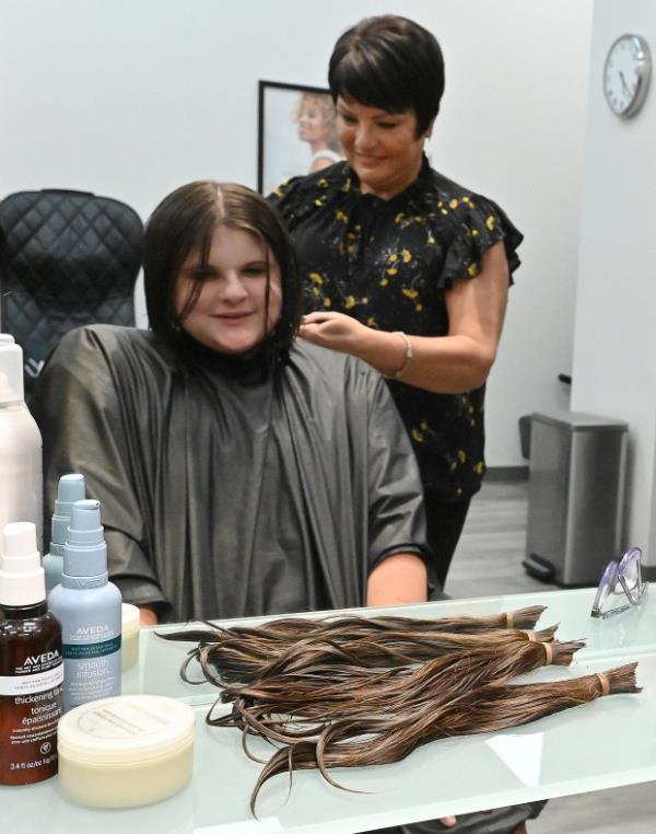 Cindy Baer, owner of The Cutting Edge Styling Studio in Frederick, styles Hannah Streaker's, hair after cutting off the hair that will be do<em></em>nated to either Locks of Love or Wigs for Kids. An Avid Orioles' fan, Hannah is making her tenth donation, a tradition every 18 mo<em></em>nths since she was four years old. (Jeffrey F. Bill/Staff photo)