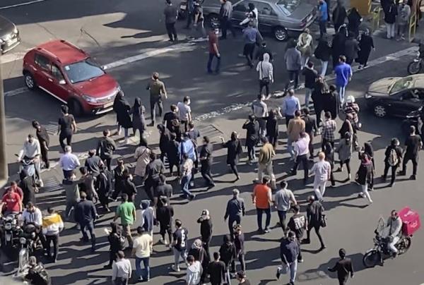 People blocking an intersection in a protest in Iran.