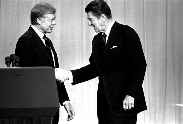 Two men in suits shake hands