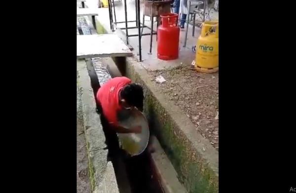 Outrage erupts as viral video shows hawker washing wok in drain water