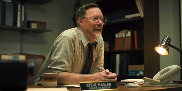 Five Nights at Freddy's Matthew Lillard at Steve Raglan sitting at desk while smiling 