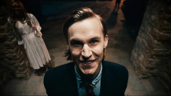 a man looks creepily toward a camera in the film the purge