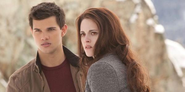 Taylor Lautner as Jacob and Kristen Stewart as Bella as they look off in the distance while outside in The Twilight Saga Breaking Dawn Part 2