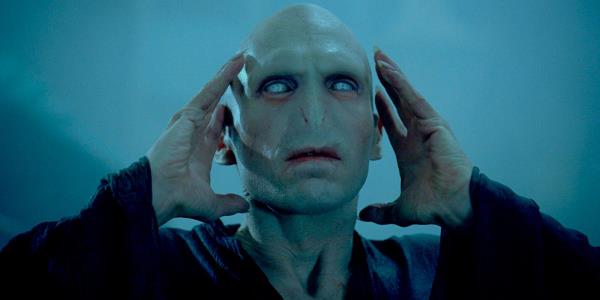 Lord Voldemort (Ralph Fiennes) putting his hands to his head in Harry Potter.