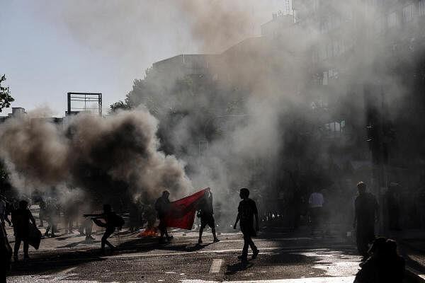 Demo<em></em>nstrators set on fire a barricade during a rally on the fifth anniversary of the protests and riots that rocked the country in 2019, in Santiago, Chile.