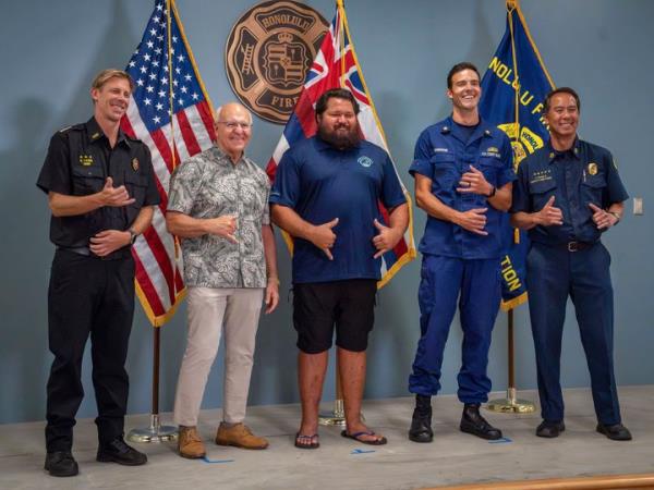 From left, Acting Director of Ho<em></em>nolulu Ocean Safety Kurt Lager, Ho<em></em>nolulu Mayor Rick Blangiardi, lifeguard Noland Keaulana, Coast Guard Lt. Cmdr. Nicholas Iannarone and Ho<em></em>nolulu Deputy Fire Chief Jason Samala make shaka gestures as they stand for a photo at a news co<em></em>nference for a rescue of a 17-year-old kayaker in Ho<em></em>nolulu on Thursday, Oct. 17, 2024. (Jennifer Nilson/U.S. Coast Guard via AP)