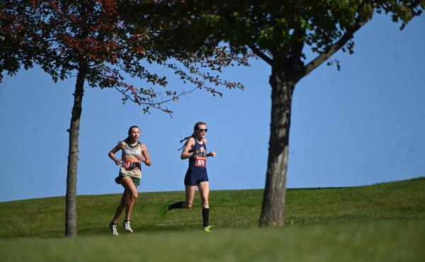 Century's Taylor Colson, left, and Manchester Valley's Elizabeth Szybalski compete in the girls varsity race during the Carroll County cross country champio<em></em>nships at McDaniel College on Tuesday. (Brian Krista/Staff)