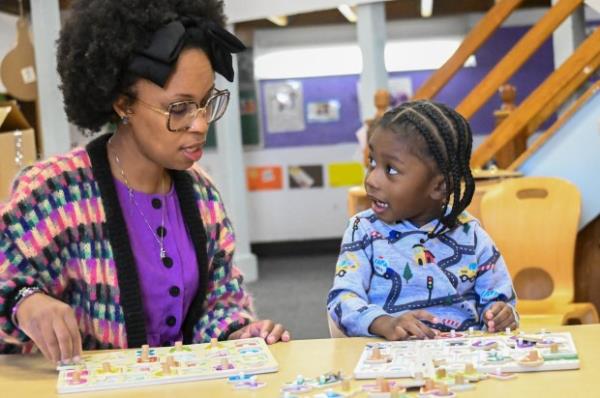 Jayden Robinson, 3, practices his letters with his teacher, Krystal Gamble, in his pre-K class in West Baltimore. (Kevin Richardson/staff)