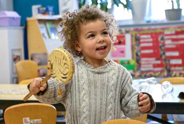 Layla, 3, plays a spinning drum during her pre-K class in West Baltimore. (Kevin Richardson/staff)