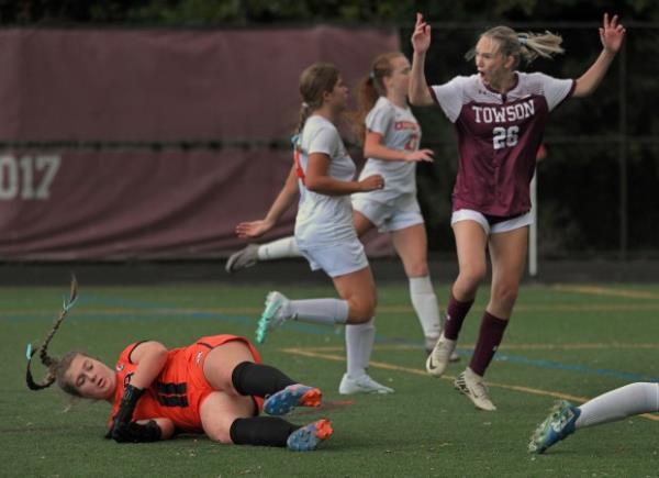 Towson's Claire Willingham, right, celebrates after scoring against Eastern Tech goalie Kylee Jones, left, in the first half of girls soccer game. (Kenneth K. Lam/Staff)