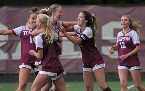 Towson's Claire Willingham, center, celebrates with teammates after scoring against Eastern Tech in the first half of girls soccer game. (Kenneth K. Lam/Staff)