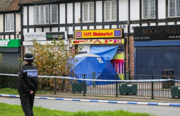 A police presence outside a row of shops on Station Road in Marston Green, Birmingham on October 30, 2024 after a 17-year-old boy was fatally stabbed yesterday (October 29). Release date ??? October 30, 2024. Police have launched a murder investigation after a 17-year-old boy was stabbed to death outside a row of busy shops. Police and ambulance crews dashed to Station Road in Marston Green, Solihull, West Mids., at around 6.20pm on Tuesday (29/10). A 17-year-old boy was found with knife injuries and despite frantic efforts to save him he was pro<em></em>nounced dead at the scene. Police arrested a boy, also 17, on suspicion of murder. The road was closed today (Wed) as police forensic teams co<em></em>nduct a fingertip search of the area.