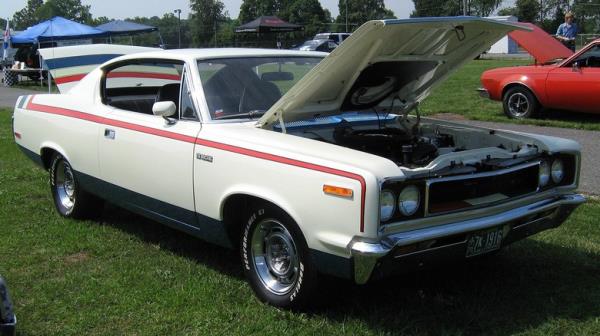 A Rebel Machine car parked with hood open at car show