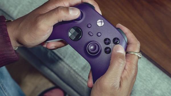 xbox purple co<em></em>ntroller holding playing