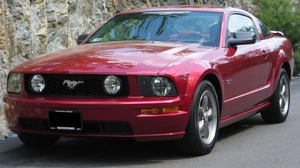 Maroon 2005 Ford Mustang GT on city street