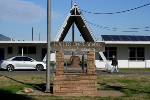 A person walks outside of Feather River Adventist School after a shooting Thursday, Dec. 5, 2024, in Oroville, Calif. (AP Photo/Terry Chea)