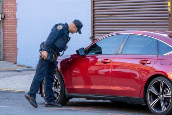 A bullet hole is pictured in the rear passenger door of a red Ho<em></em>nda Accord after a shooting in front of Room 1Hundred on Jamaica Ave. near New Jersey Ave. in East New York, Brooklyn early Monday, Dec. 2, 2024. (Theodore Parisienne / New York Daily News)