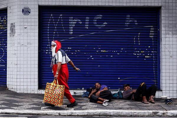 A man dressed as Santa Claus, who identifies as "Sultan Das Matas," walks, in Sao Paulo